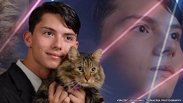 boy holding cat with lasers in the background